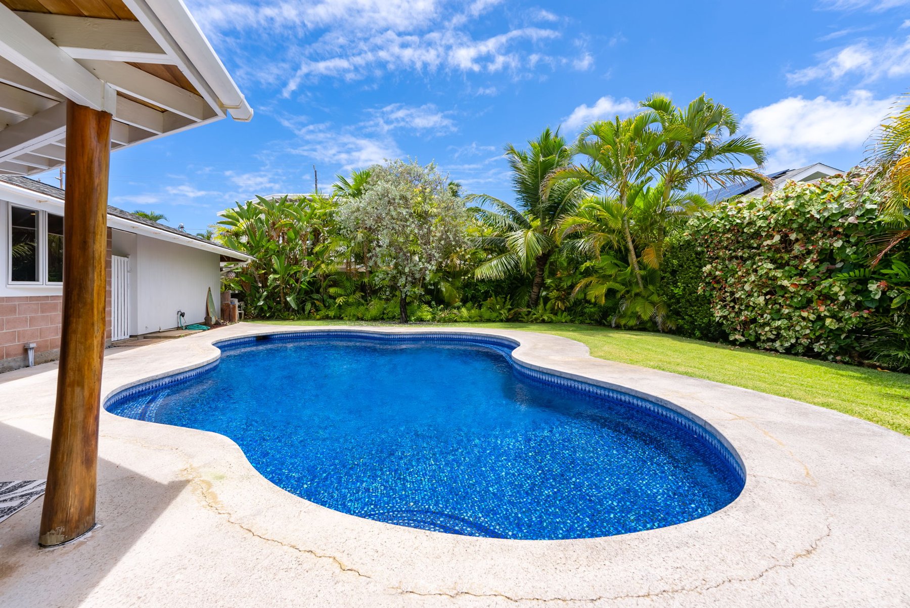 Backyard pool seen from a covered lanai at a Kailua home