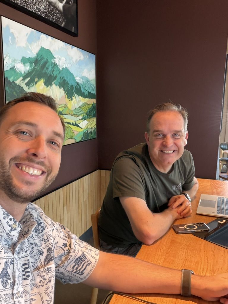 Matt Ball talking story with a client over coffee