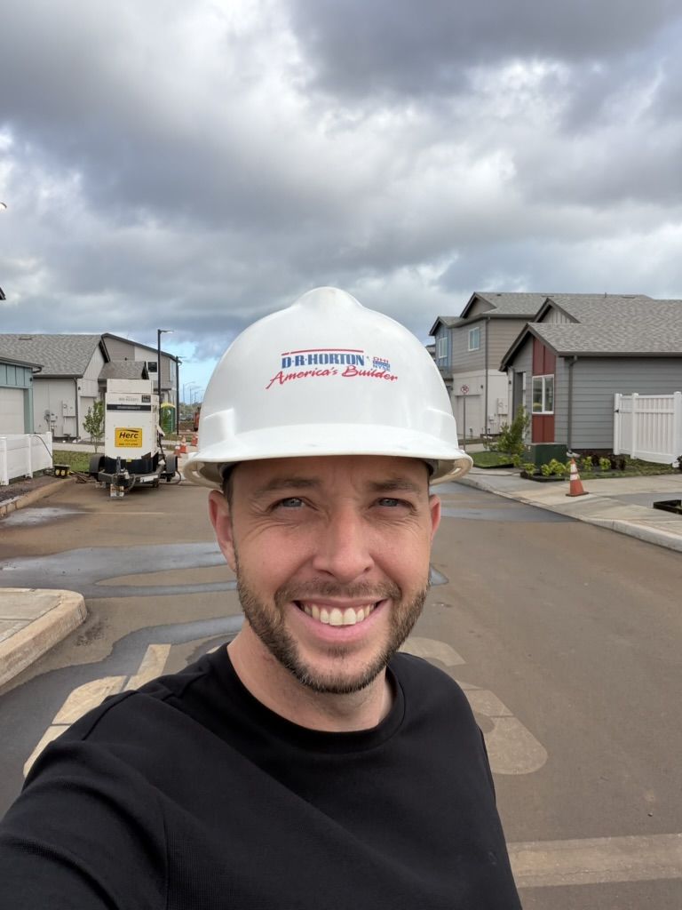 Matt Ball in a hard hat at a new construction home site on Oahu